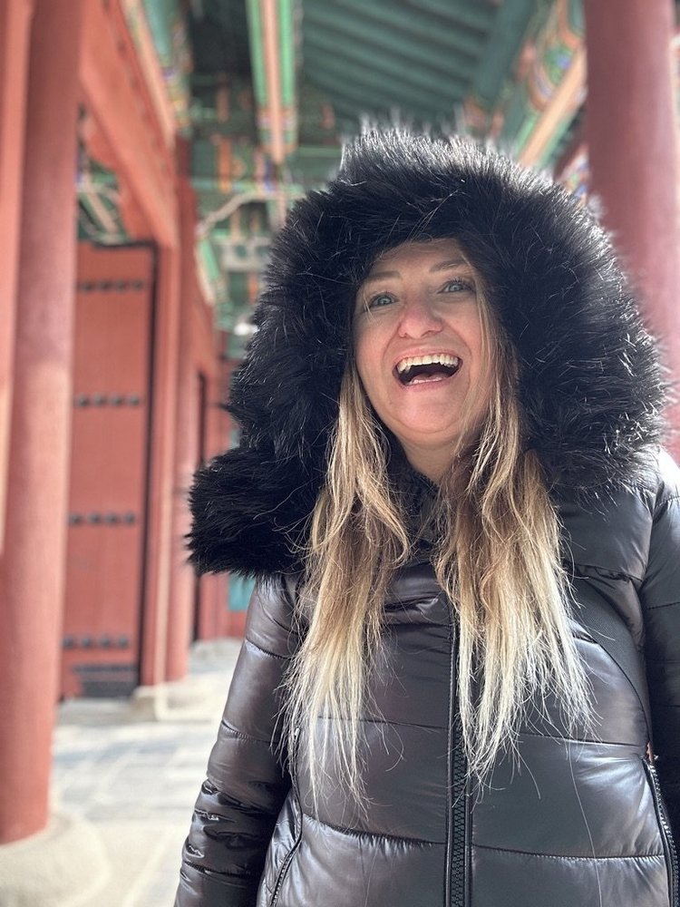 Laughing in a fur hood at a Seoul palace