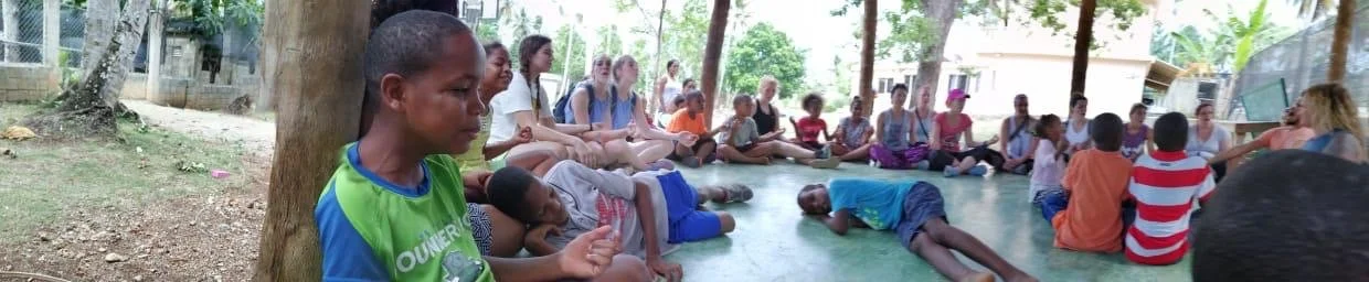 Retreat community circle with local families in the Dominican Republic