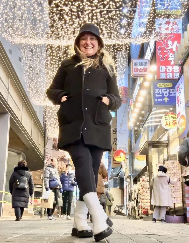 Shelley on a lit-up Seoul shopping street