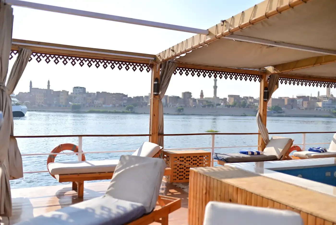 Lounge chairs on the shaded sun deck of a dahabiya on the Nile