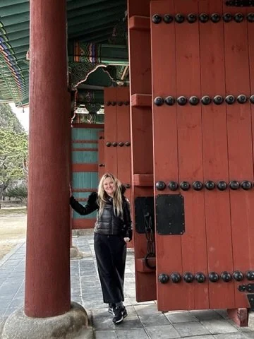 Shelley at the red gates of Gyeongbokgung Palace in Seoul