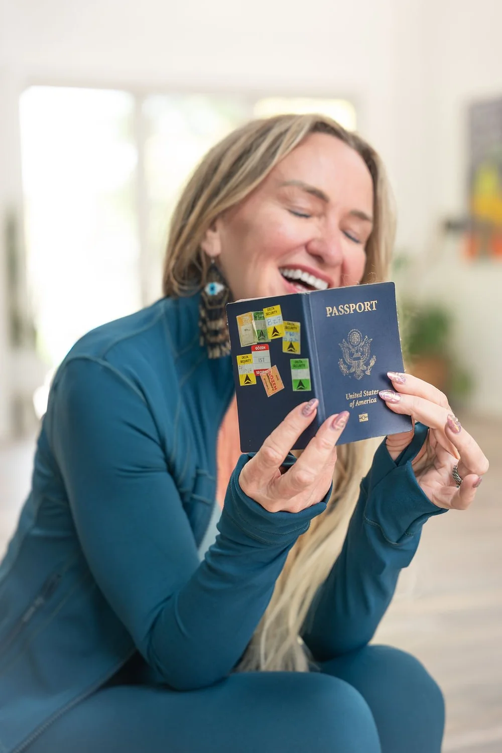 Shelley Carroll, founder of DDY Travels, laughing with her passport, host of the Egypt eclipse yoga retreat