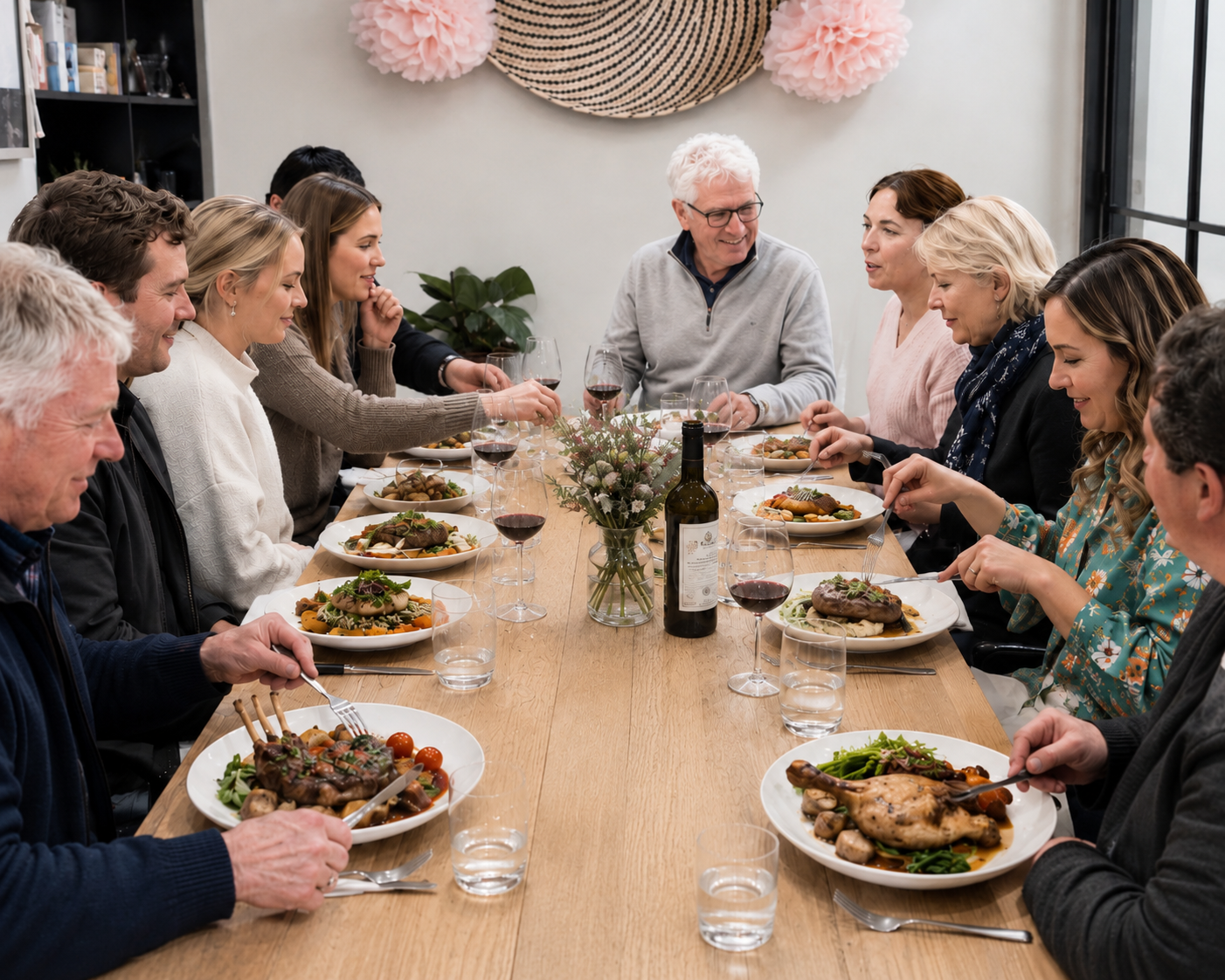 Guests seated along a long table sharing a catered meal at Wyton