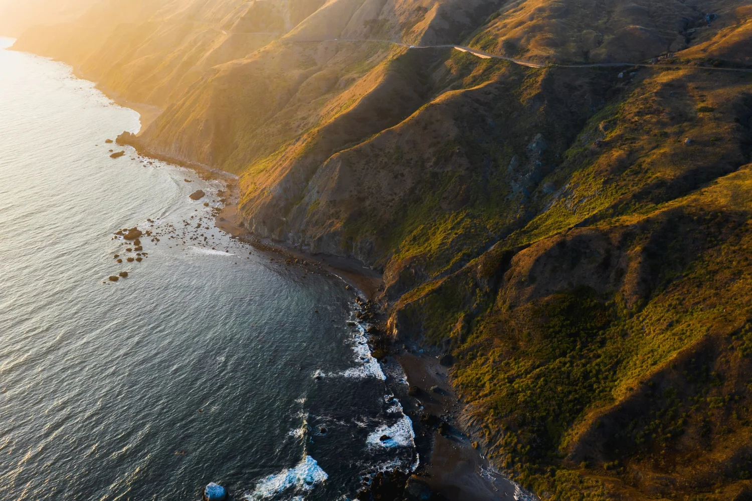Golden evening light across the coastal cliffs and Pacific ocean