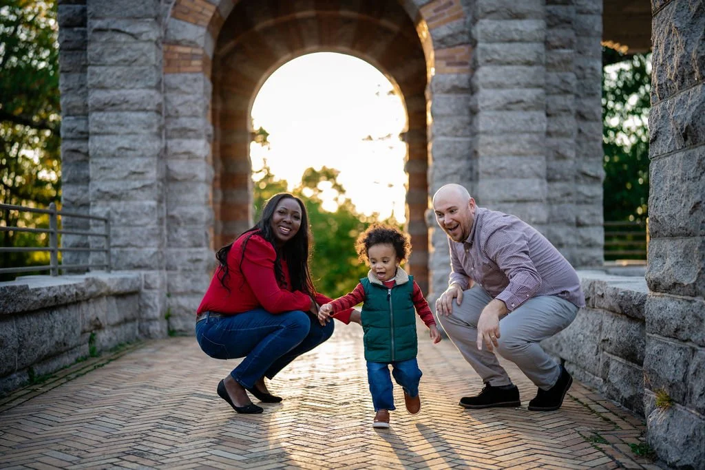 Eunice and Jake with Samuel beneath a stone arch