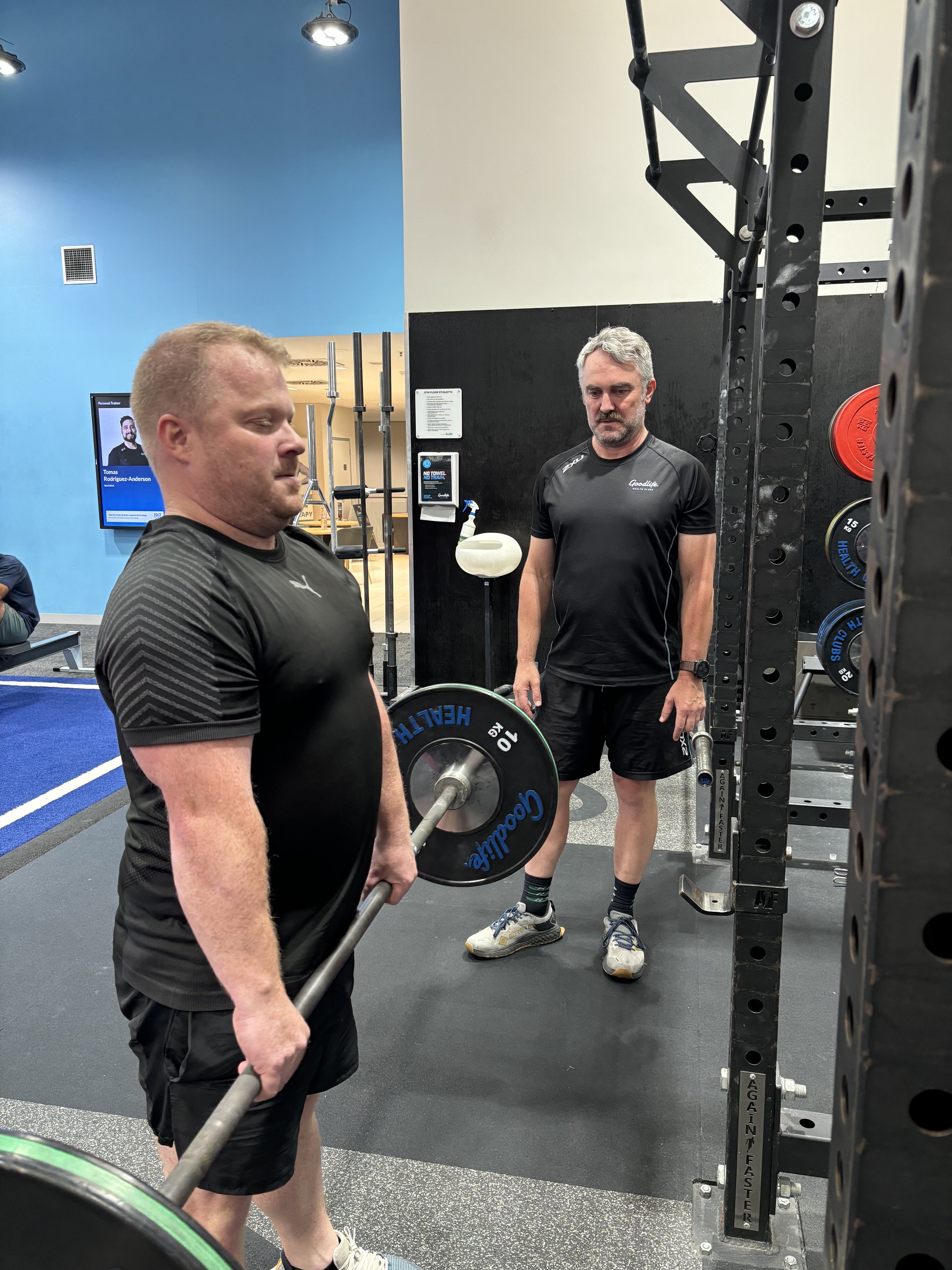 Paul Wenske coaching a client during a strength training session