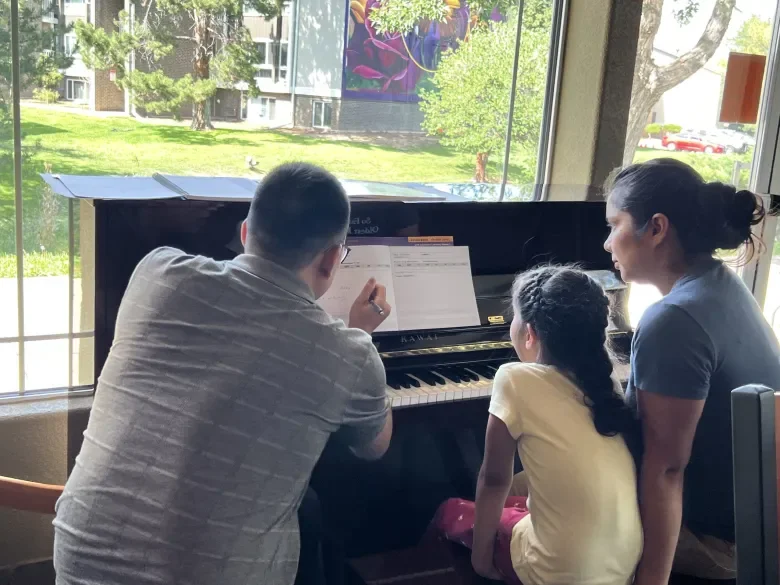 Piano lesson at a Boulder Housing Partners community