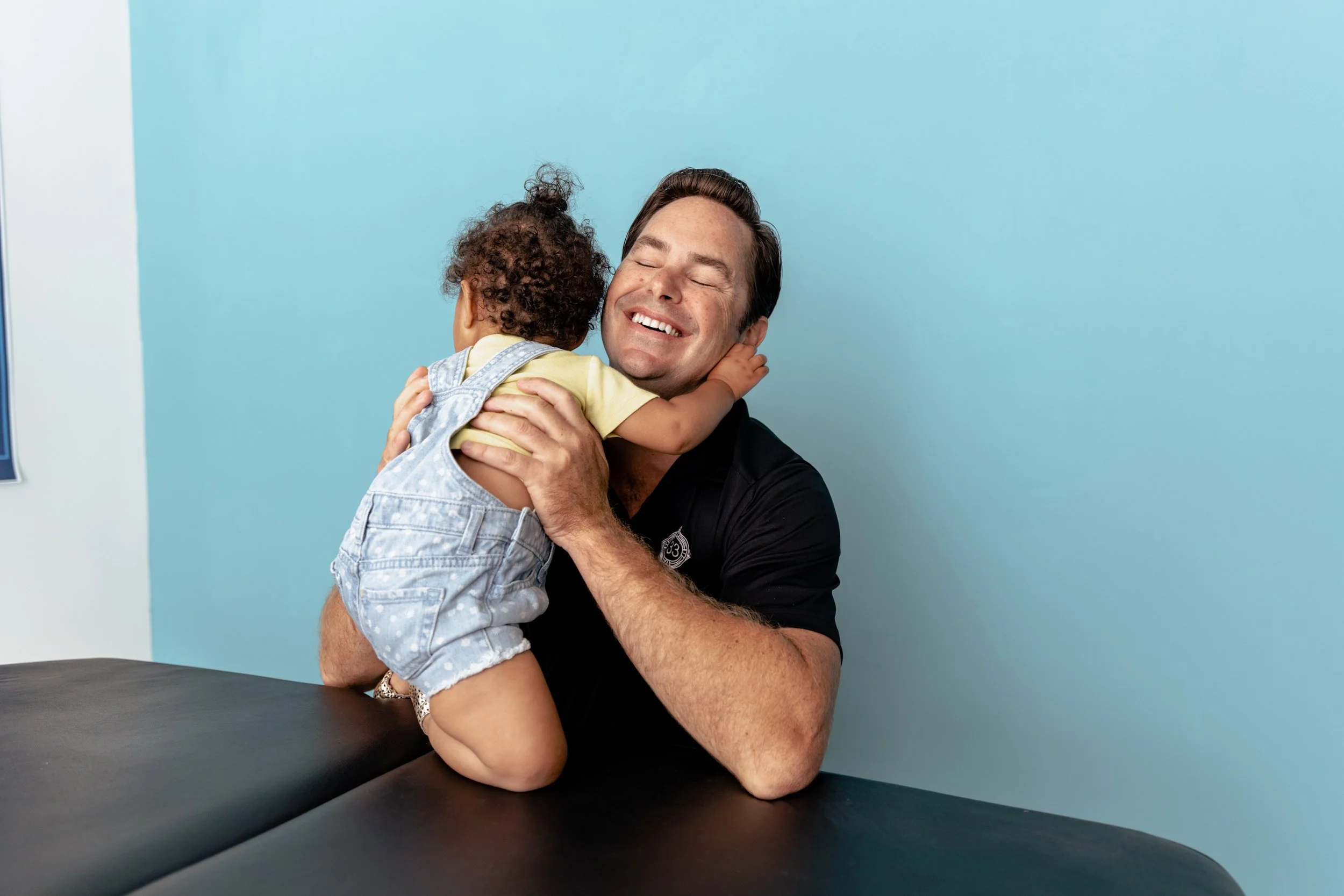 Dr. Brian of Thirty Three Chiropractic caring for a young patient