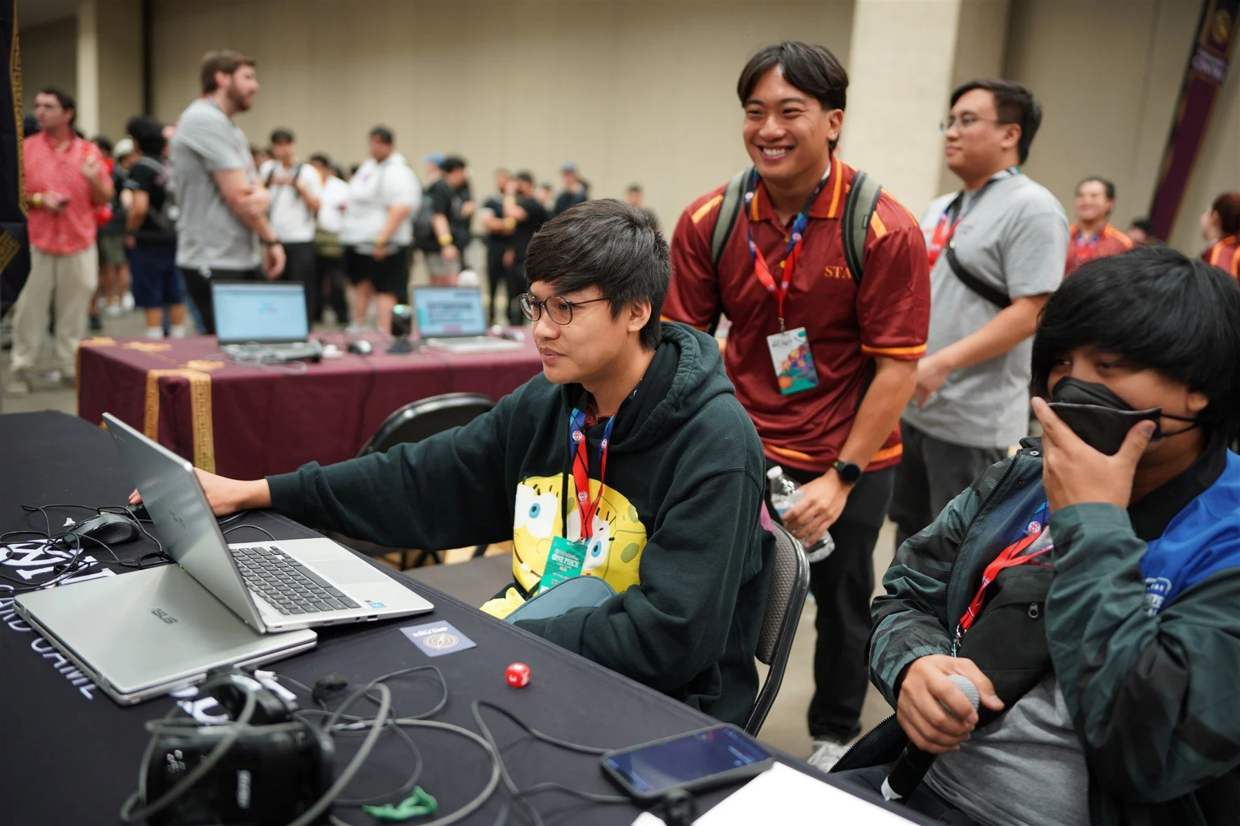 Dallas event team members working together at laptops beside the tournament floor
