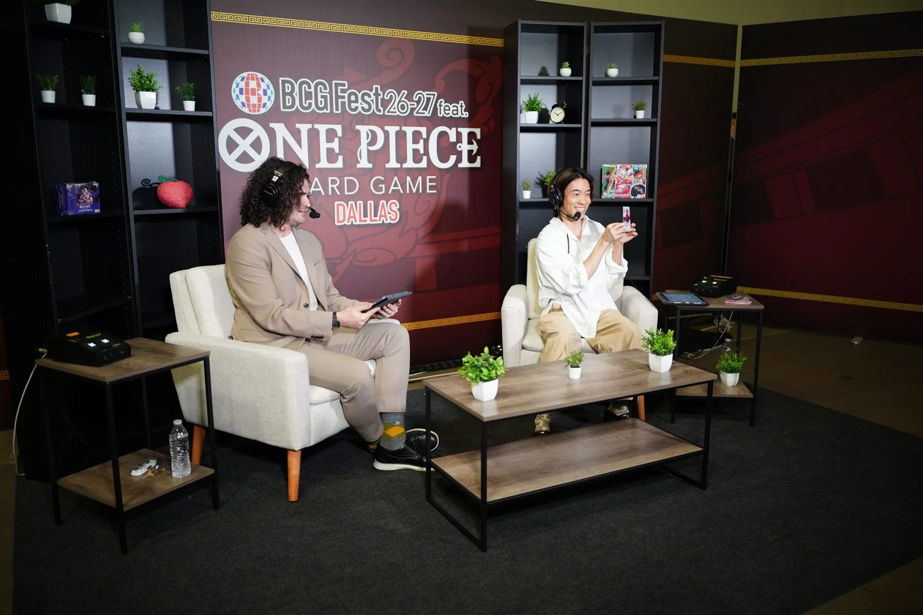 Two participants wearing headsets and seated in the official Dallas ONE PIECE interview set
