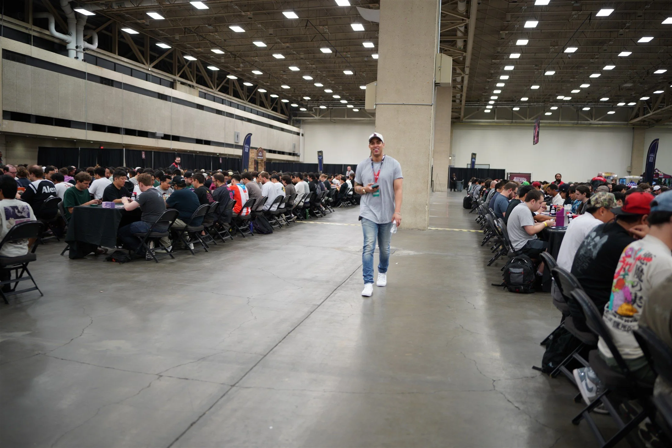 Rows of players competing at tables across the Dallas ONE PIECE CARD GAME tournament hall