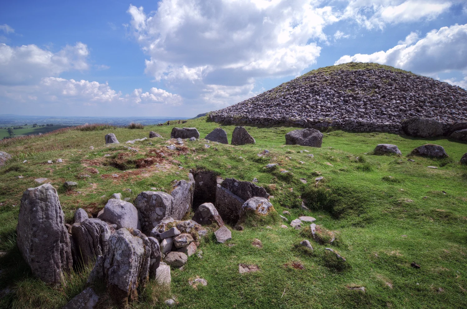 A stone cairn at Loughcrew beneath a colorful dawn sky