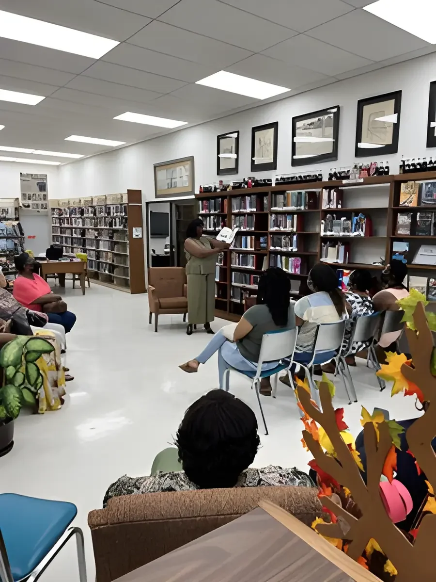 Daphne Tillman Perry reading to an audience at a community library