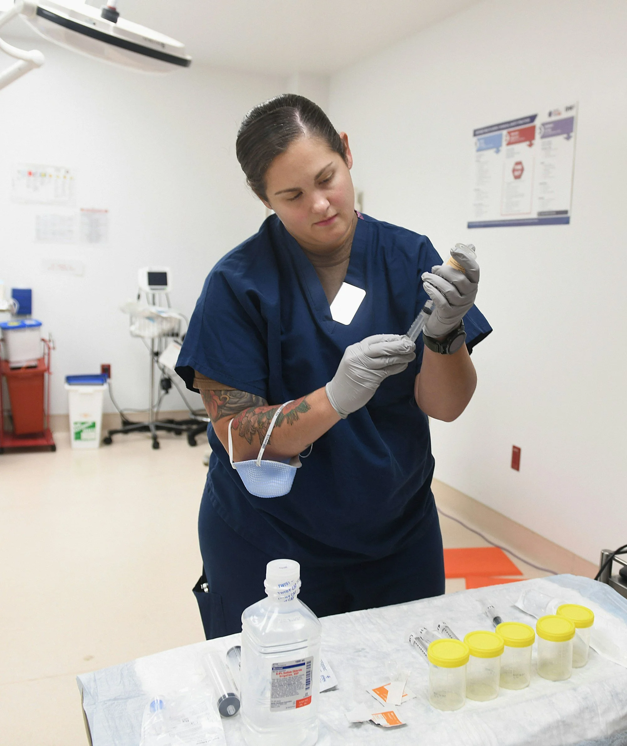 Nurse preparing supplies in gloves