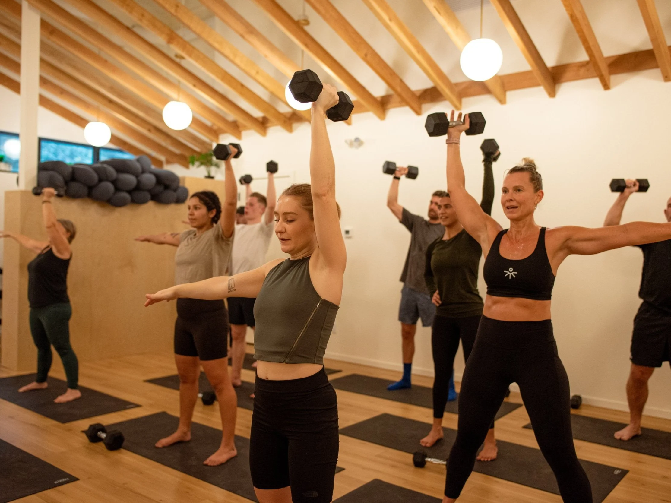 LAND strength class lifting dumbbells together