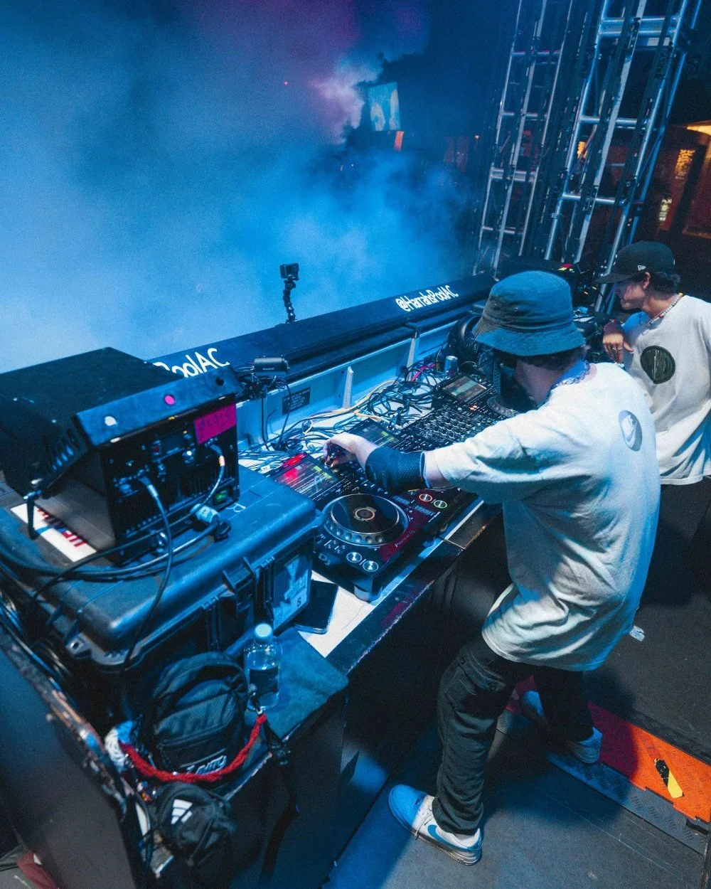 DJ performing in the booth through smoke and stage lights at The Pool After Dark in Atlantic City