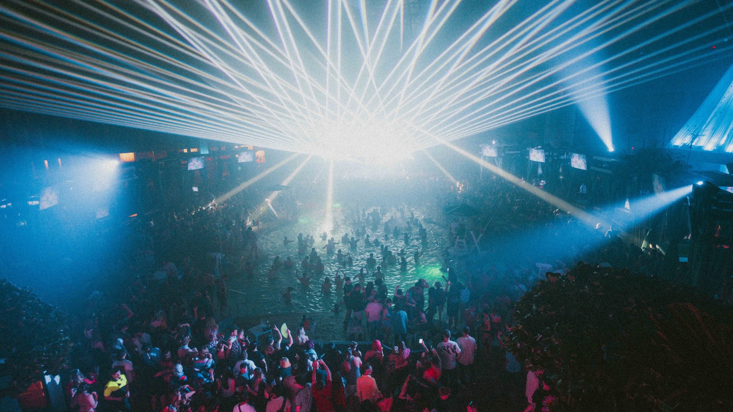 Laser light show over a packed crowd at The Pool After Dark, Harrah's Resort Atlantic City, an event powered by Fame Hospitality
