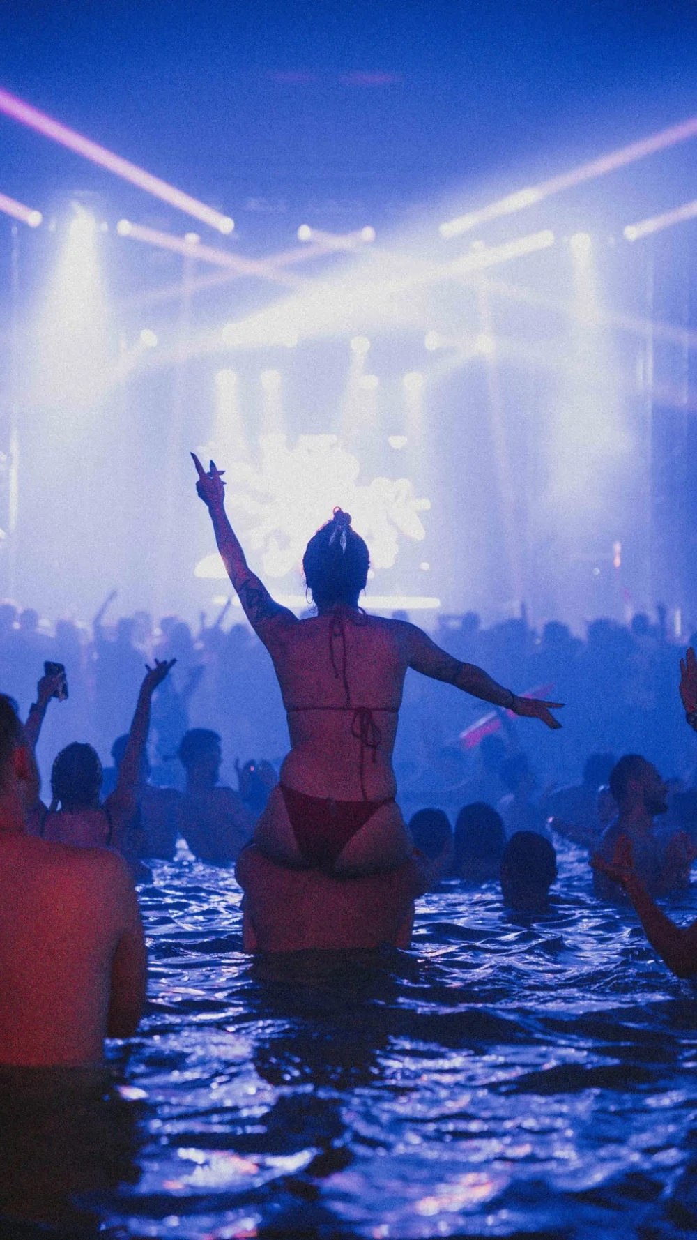 Fan on shoulders in the water during a night swim party at The Pool After Dark in Atlantic City