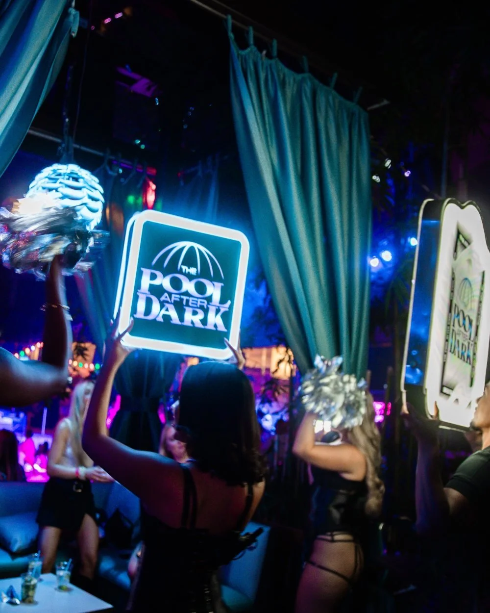 Bottle presentation with a light-up Pool After Dark sign at a VIP cabana at Harrah's Resort Atlantic City