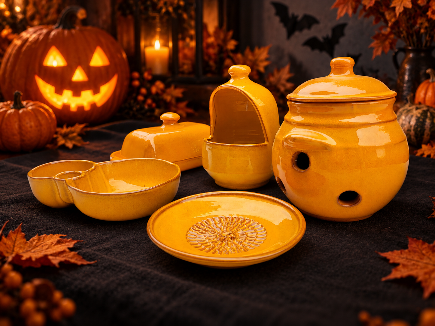 Orange Spanish pottery with a glowing jack-o-lantern and Halloween decorations