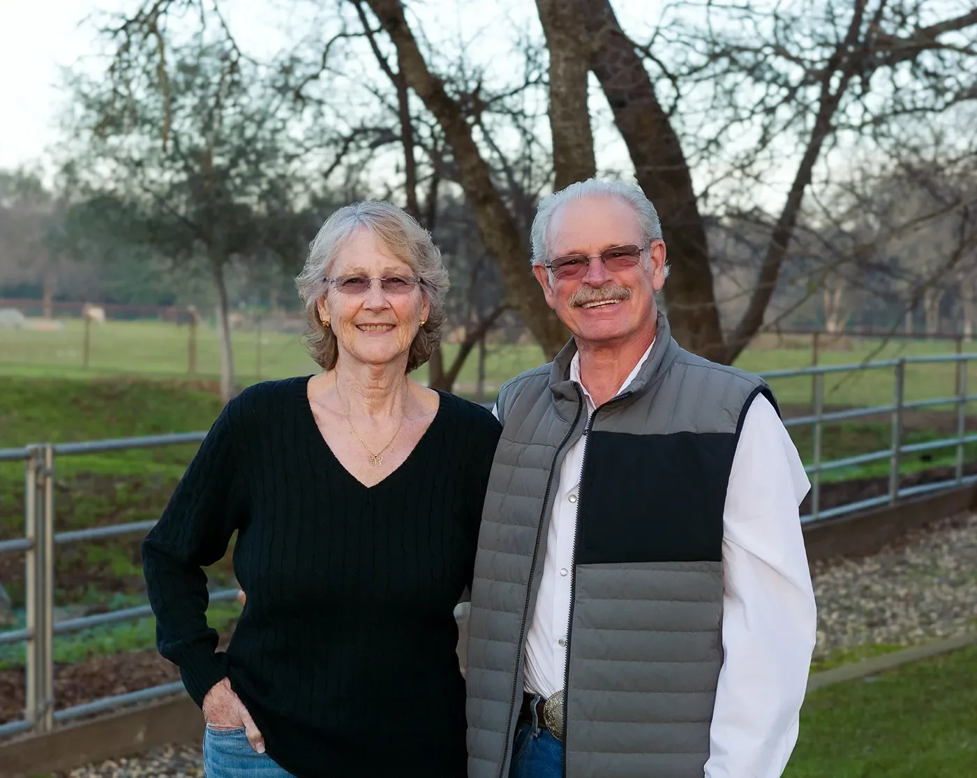 Charlie and Gayle seated together on the farm