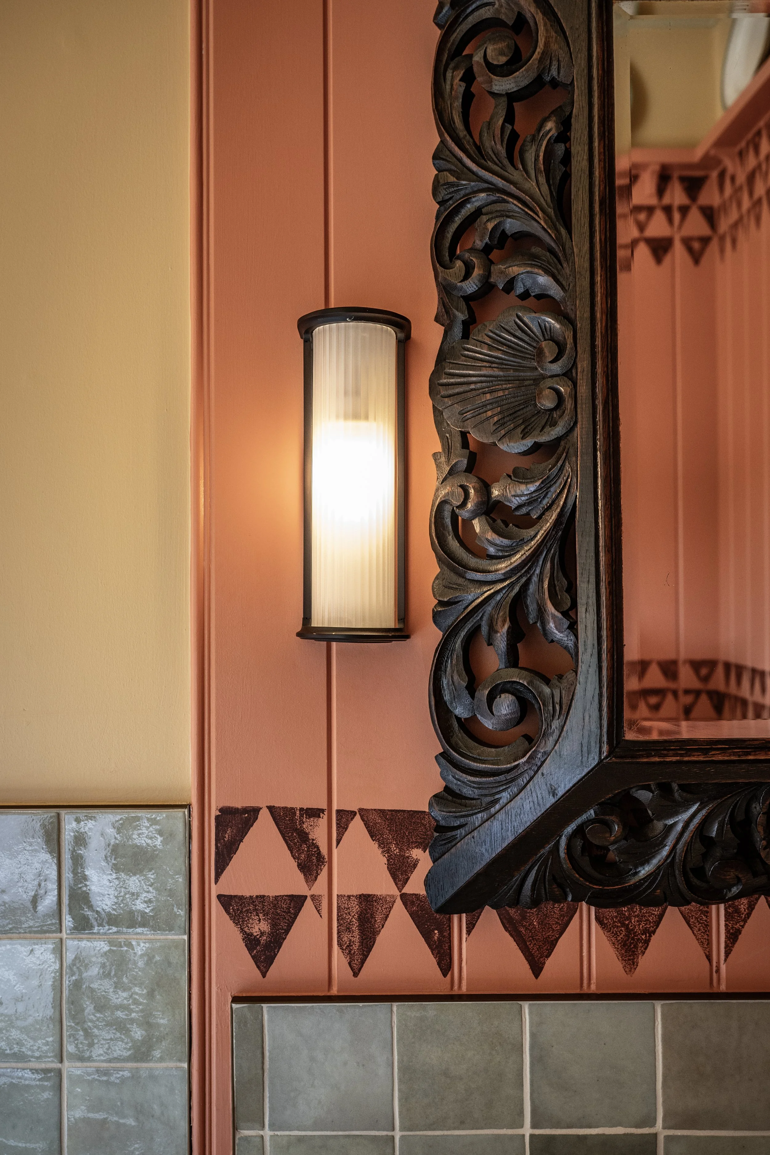 Carved mirror and wall sconce detail at Loch Lomond Arms, Luss, Scotland