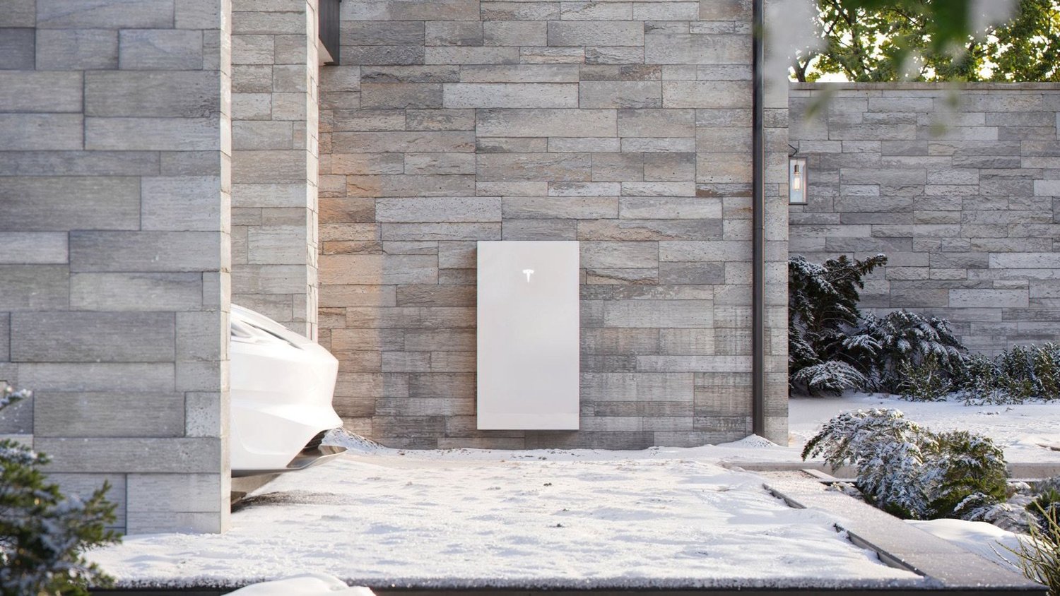 Powerwall 3 mounted on a stone wall in winter