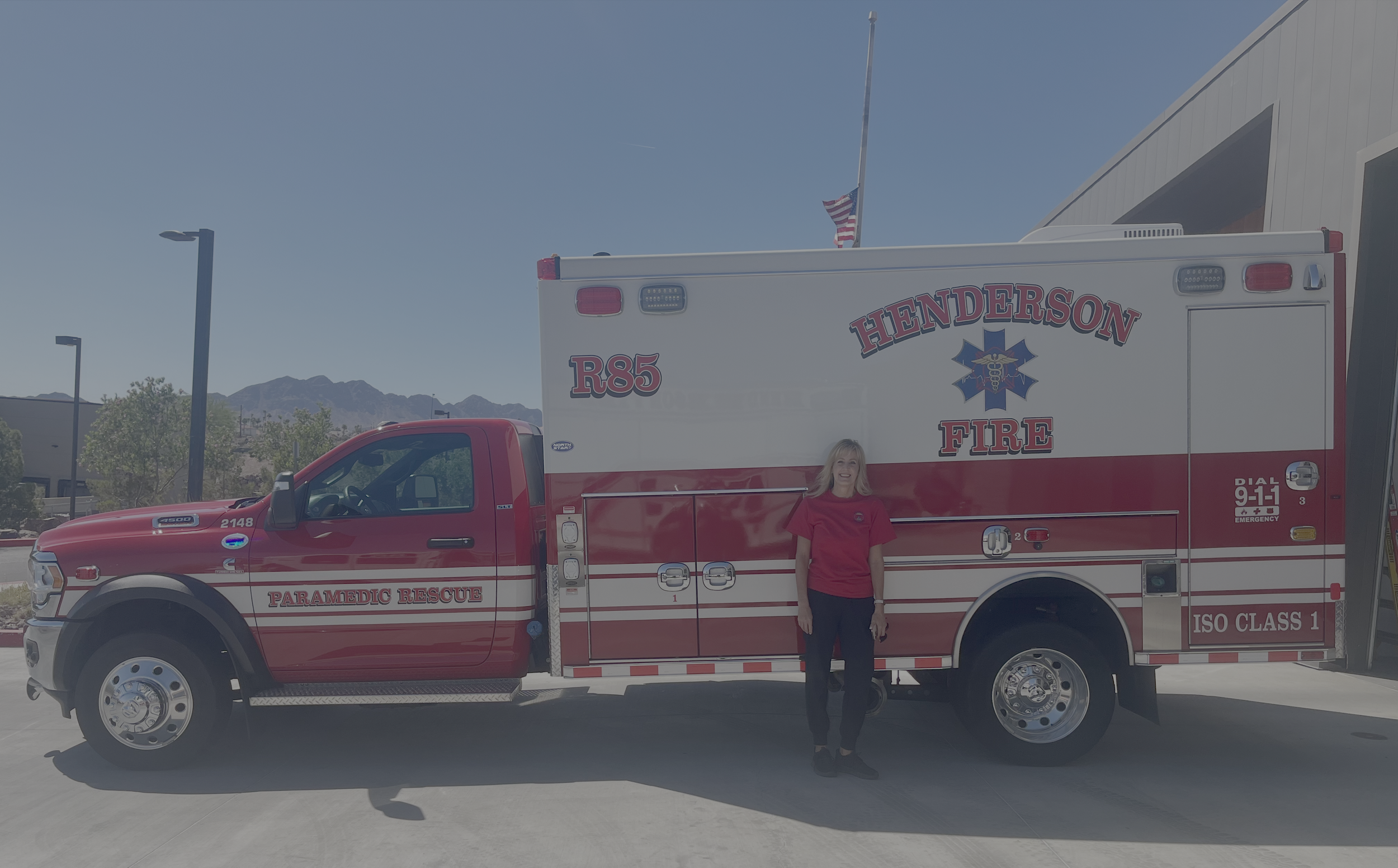 Melissa Hardy standing in front of a Henderson Fire paramedic rescue truck