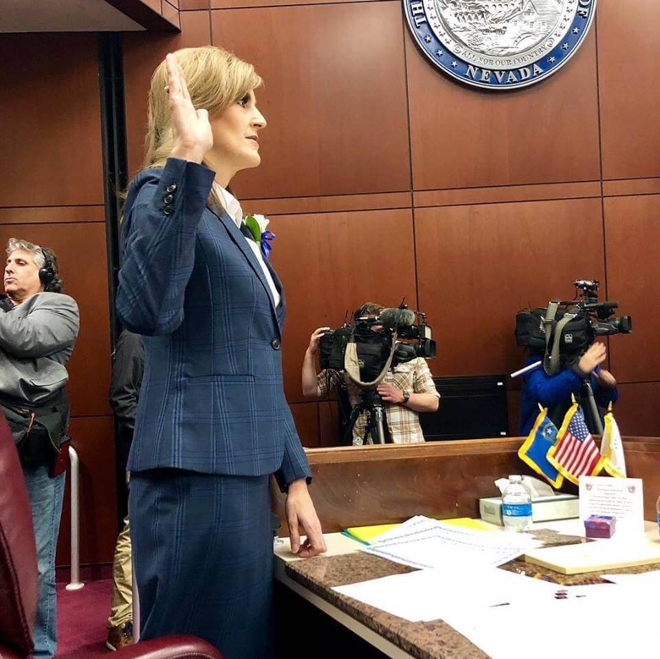 Melissa Hardy taking the oath of office in the Nevada Assembly chamber as news cameras record