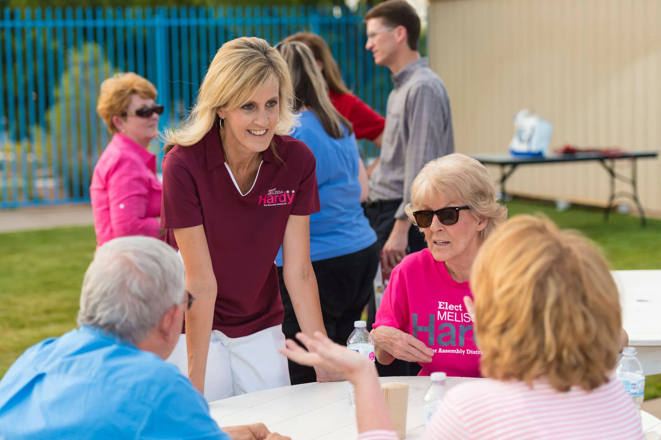Melissa Hardy talking with neighbors at an outdoor community event