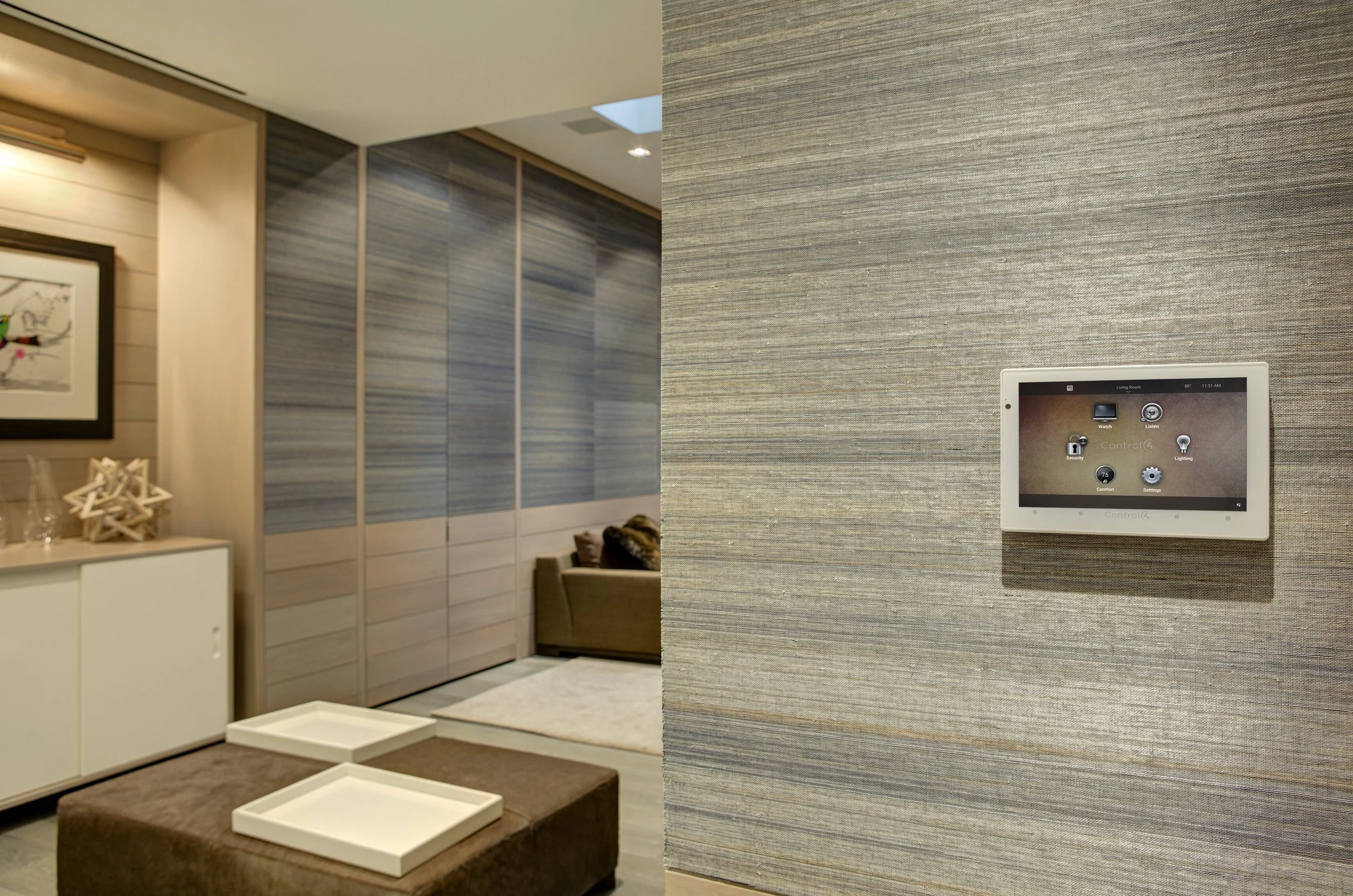 Wall-mounted Control4 touchscreen providing room-by-room smart-home control