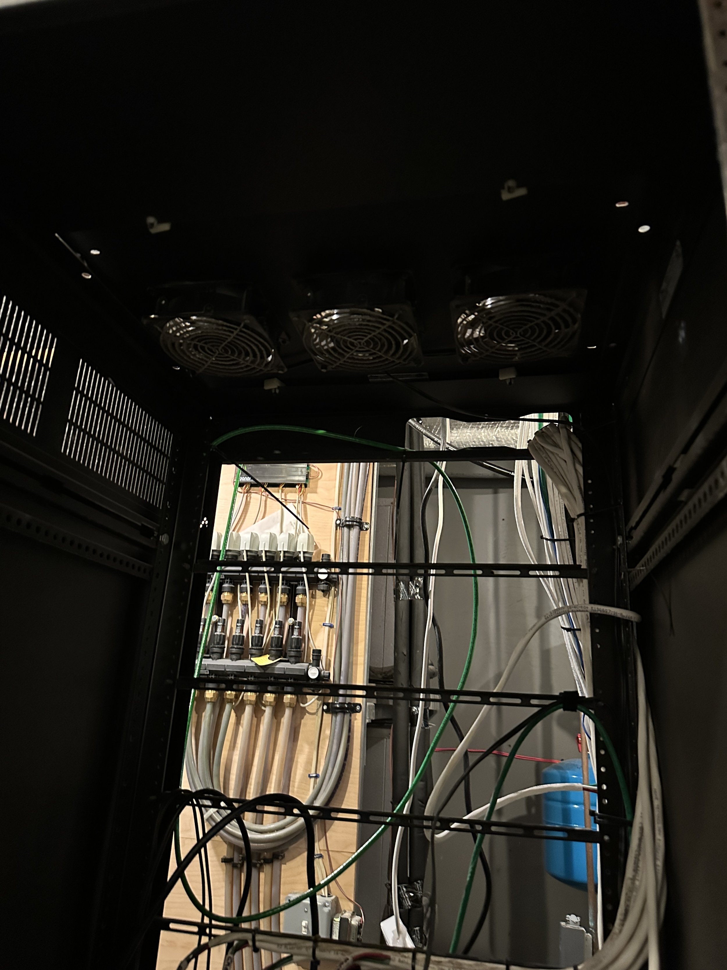 Disorganized wiring behind equipment rack