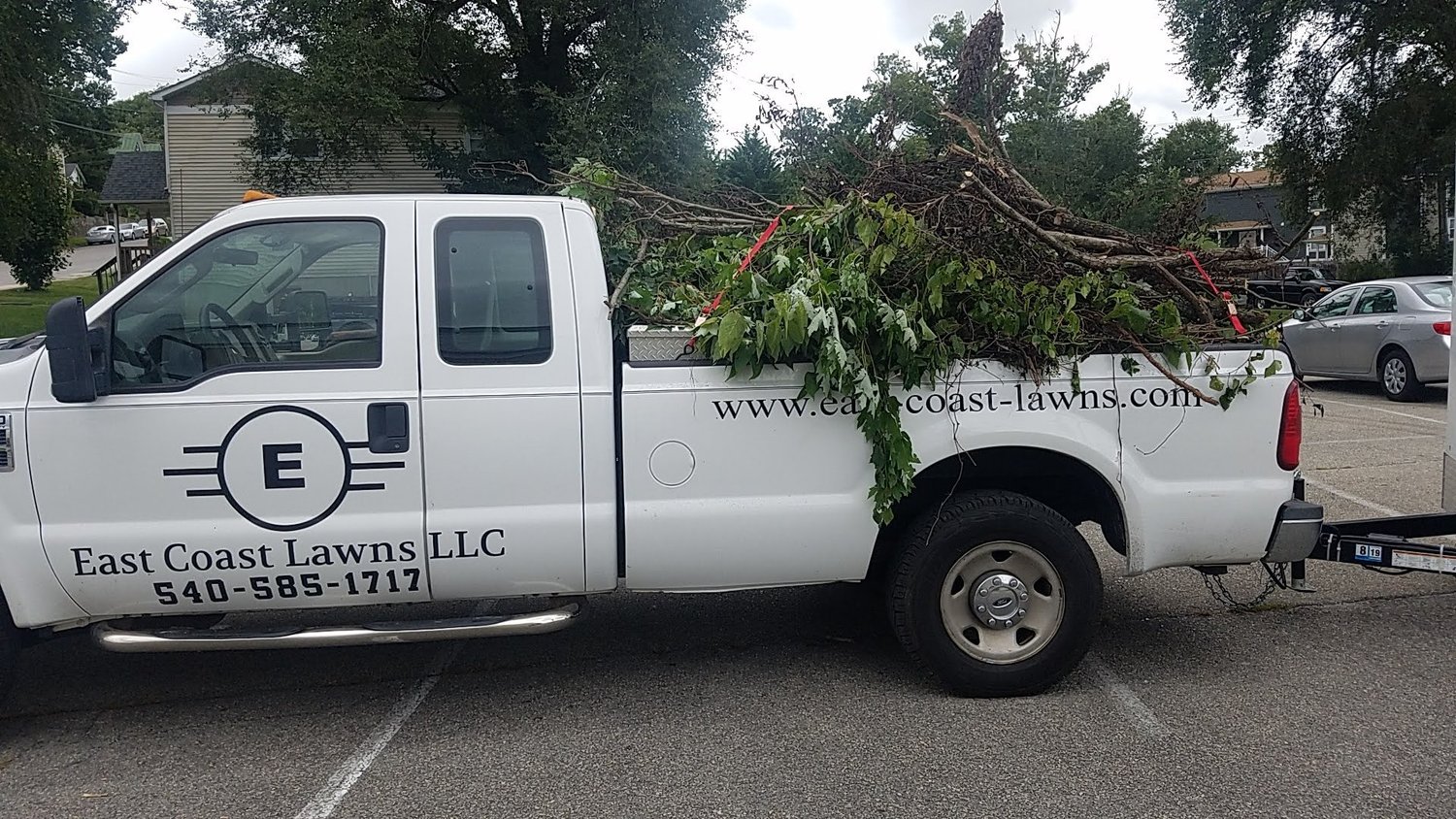 East Coast Lawns truck loaded with branches for hauling