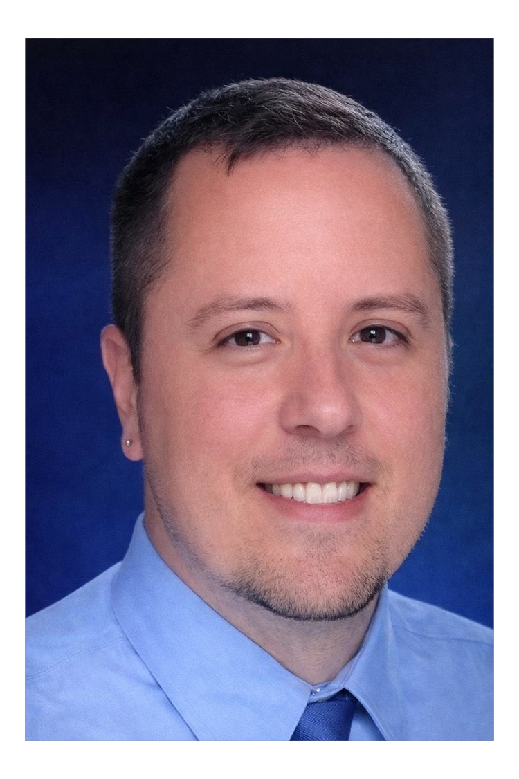 RFT Supervisor John Becvar: Professional headshot of a man in a blue shirt with a dark blue background
