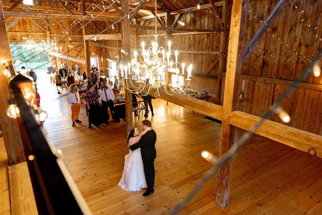A first dance seen from the barn loft, under a big chandelier