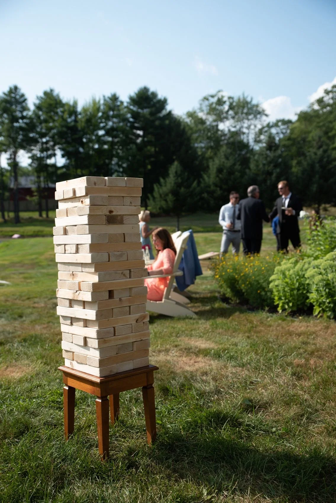 Guests playing giant Jenga on the lawn during cocktail hour