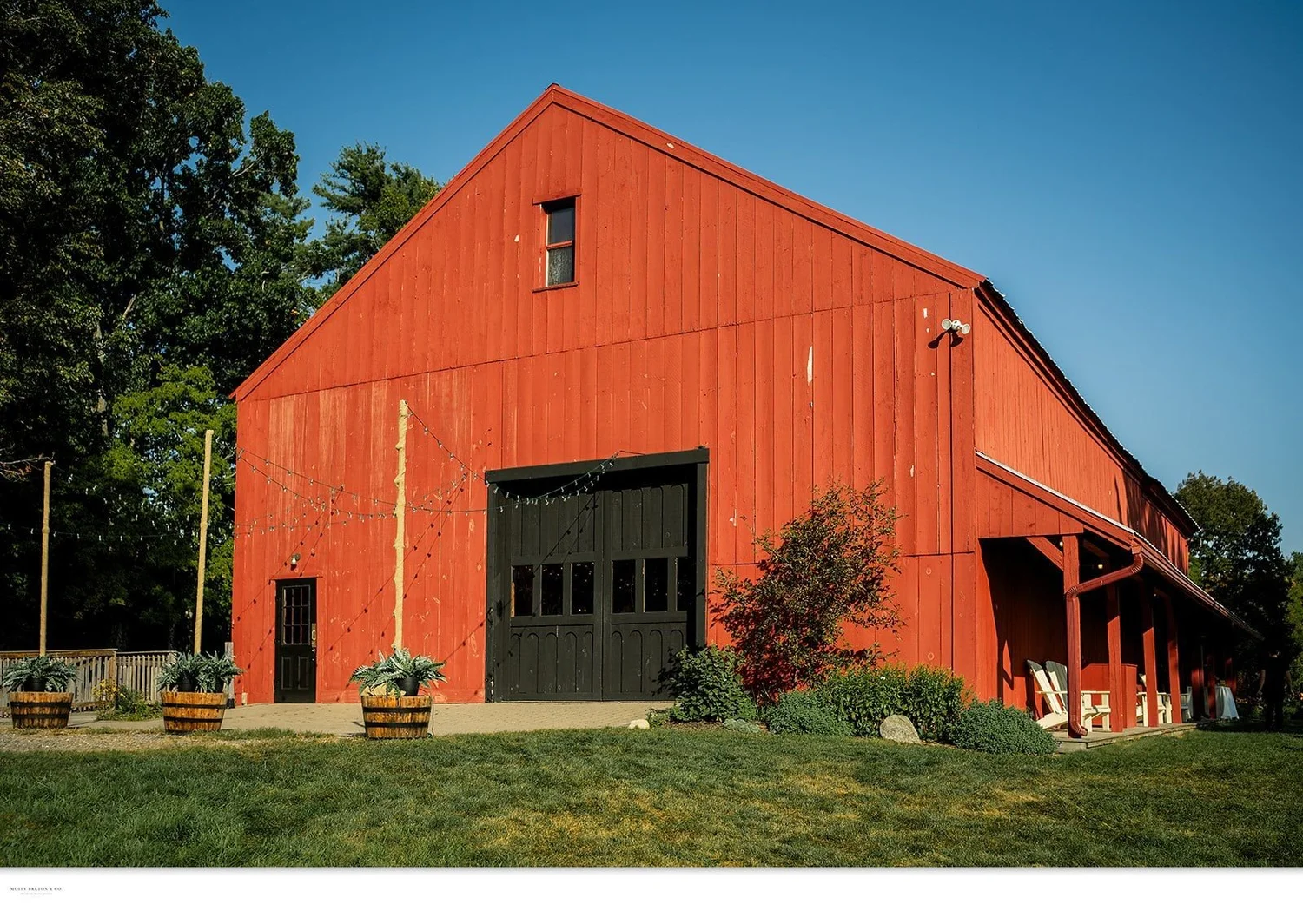 The red timber-frame barn at William Allen Farm in Pownal, Maine on a summer day