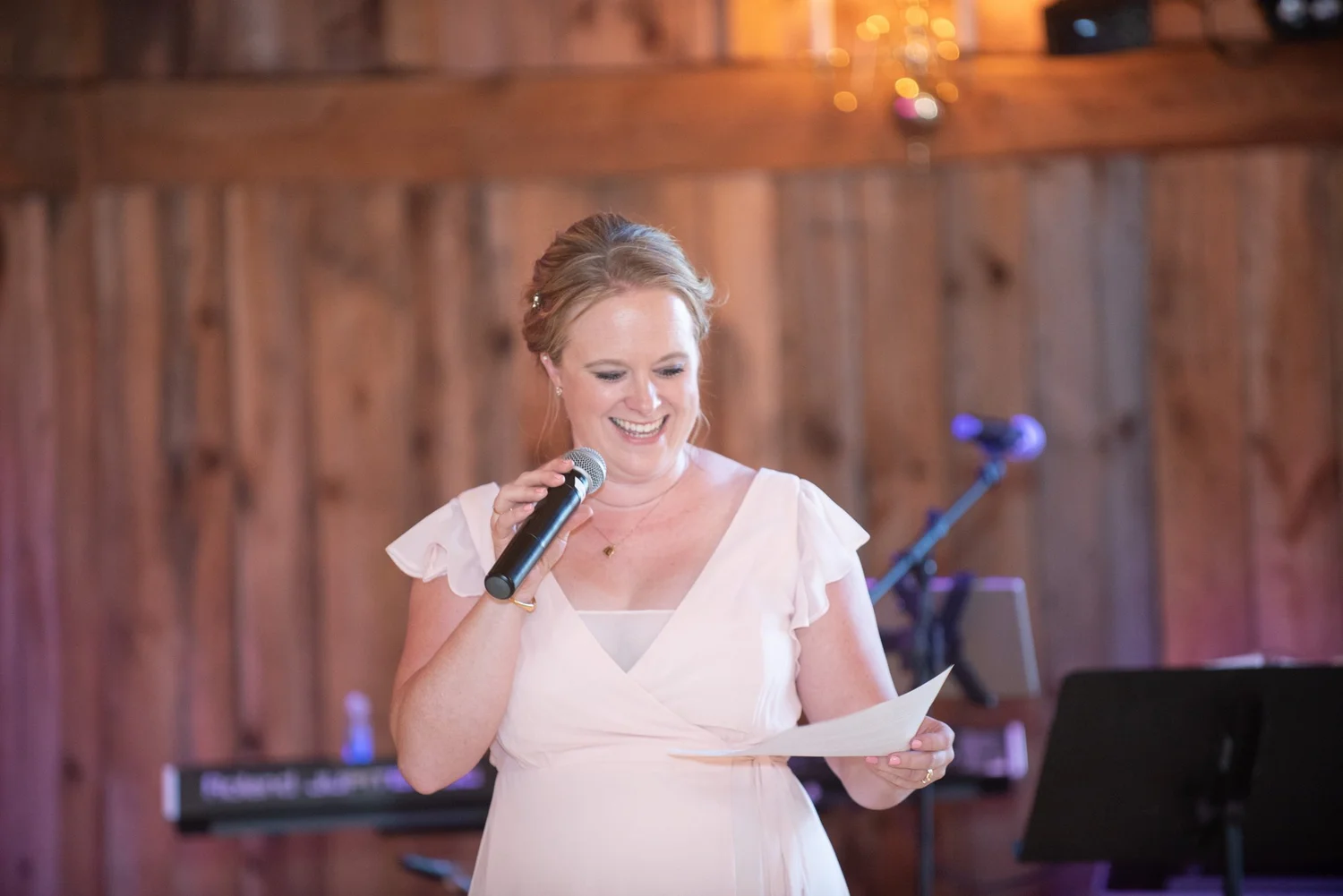 Kate Sansom, owner of William Allen Farm, smiling as she gives a toast in the barn