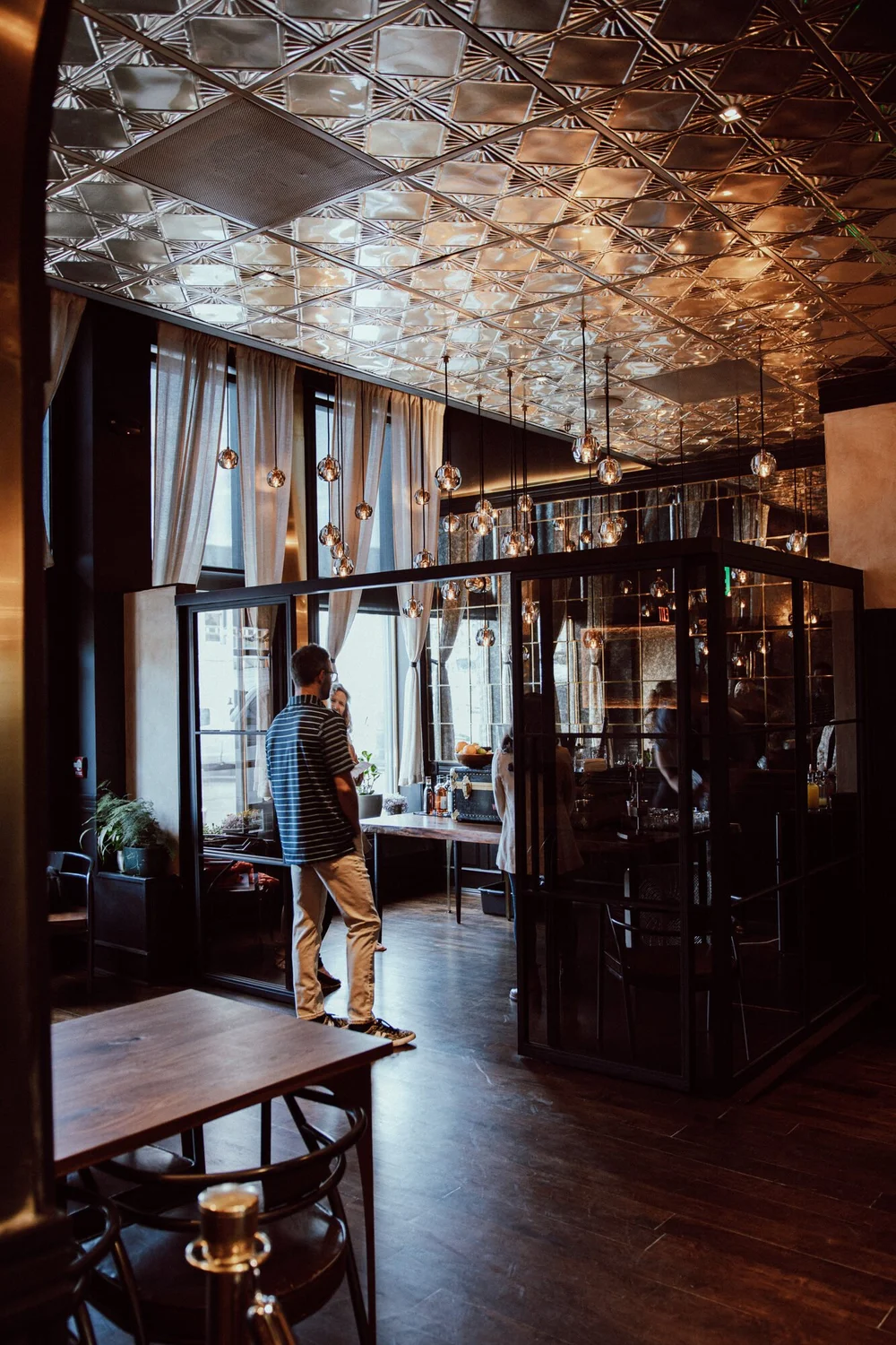 The glass partition and tin ceiling