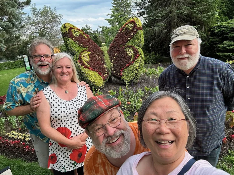 Friends in the garden after the cruise · Boston–Quebec City 2025