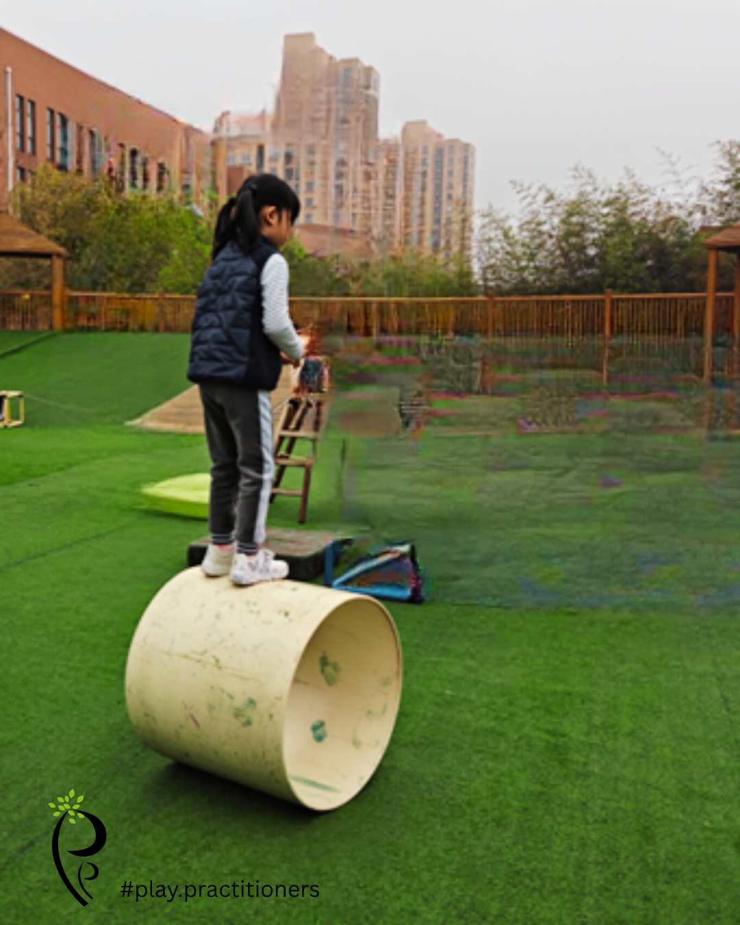 child taking a risk balancing on a barrell