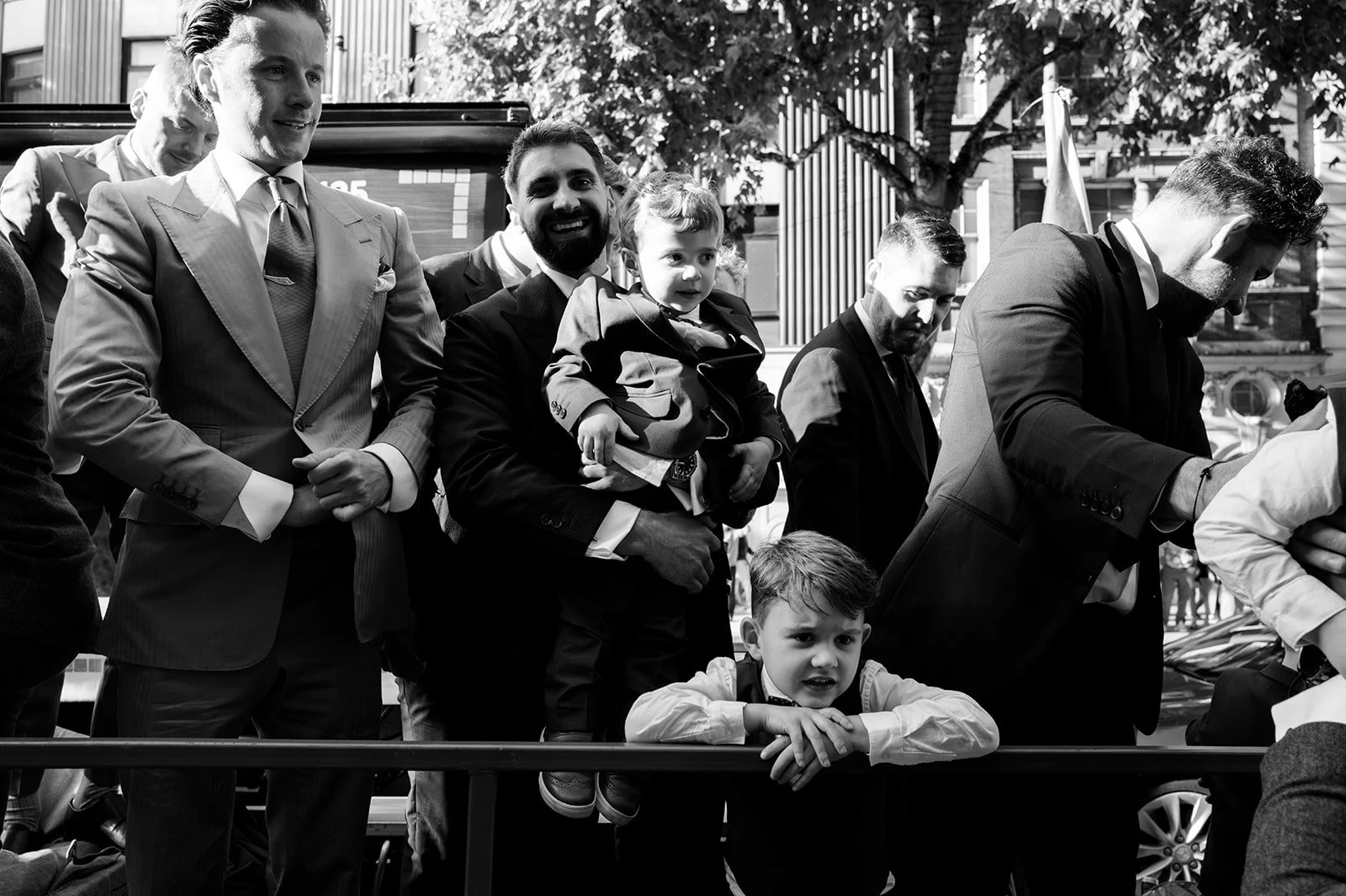 Groomsmen and children on the open top of the Routemaster bus