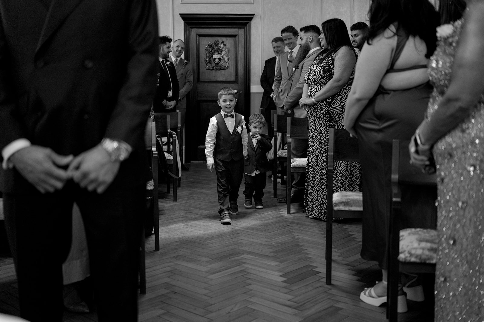Page boy walking down the aisle at Chelsea Town Hall
