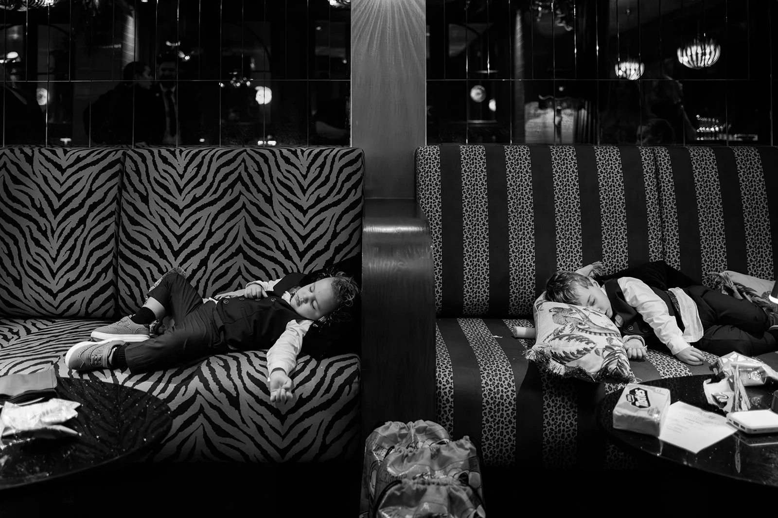 Children asleep on zebra print sofas at the end of the night