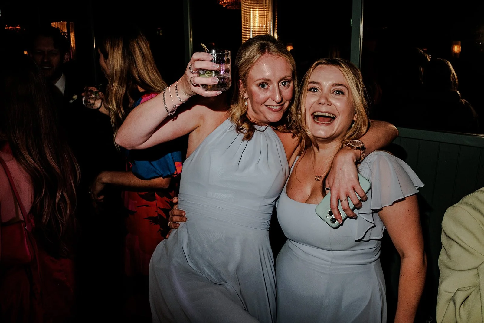 Bridesmaids celebrating and dancing at the Limekiln evening reception, drinks raised, huge smiles
