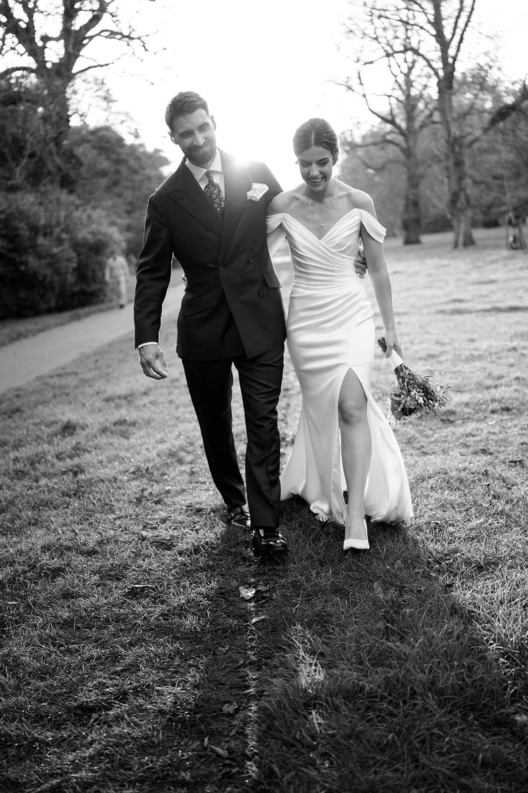 Nat and Josh walking and laughing in the park