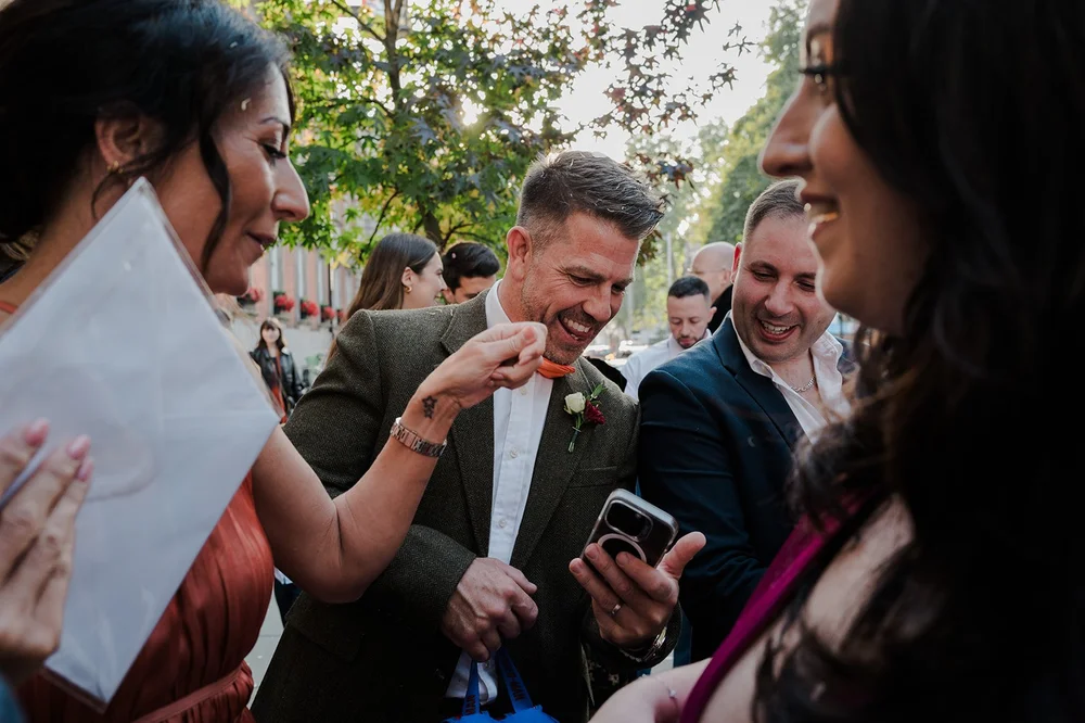 Guests greeting a newly married couple outside Chelsea Old Town Hall