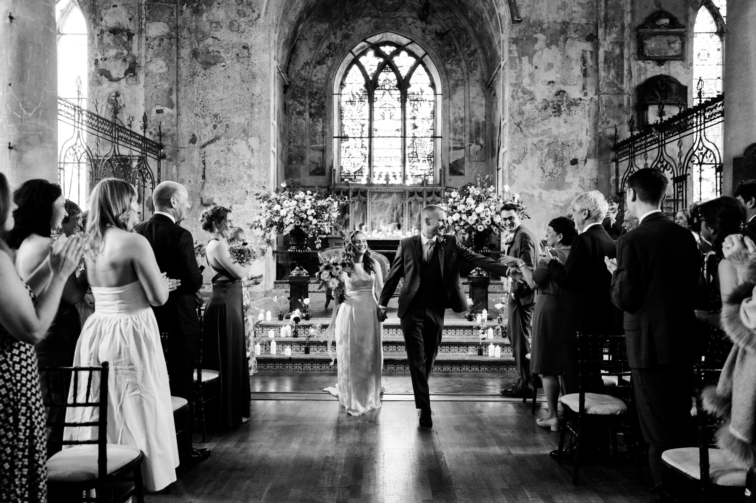 Bride and groom walking down the aisle at their church wedding ceremony