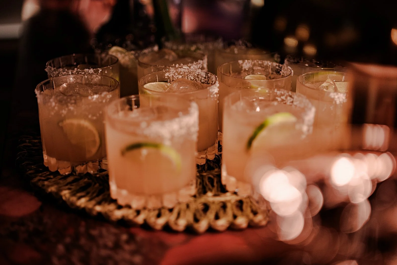 A tray of perfectly prepared margarita cocktails with salted rims and fresh lime slices at the Limekiln evening reception — detail shot