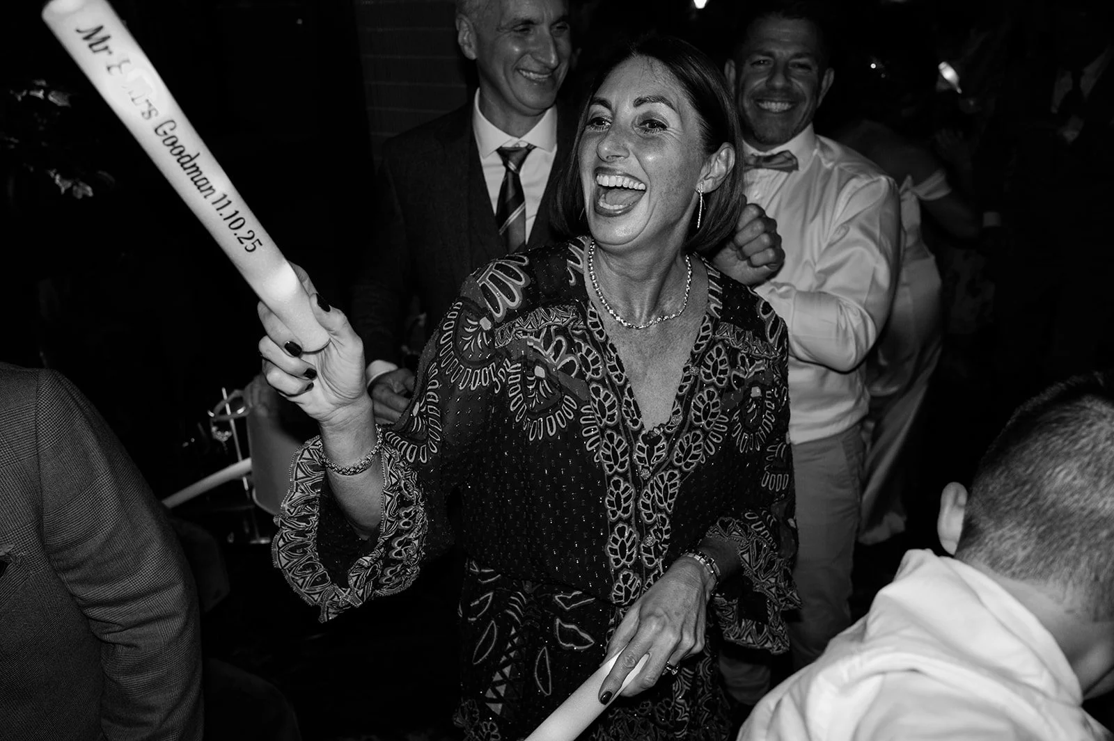 Guest laughing with a foam stick on the dance floor